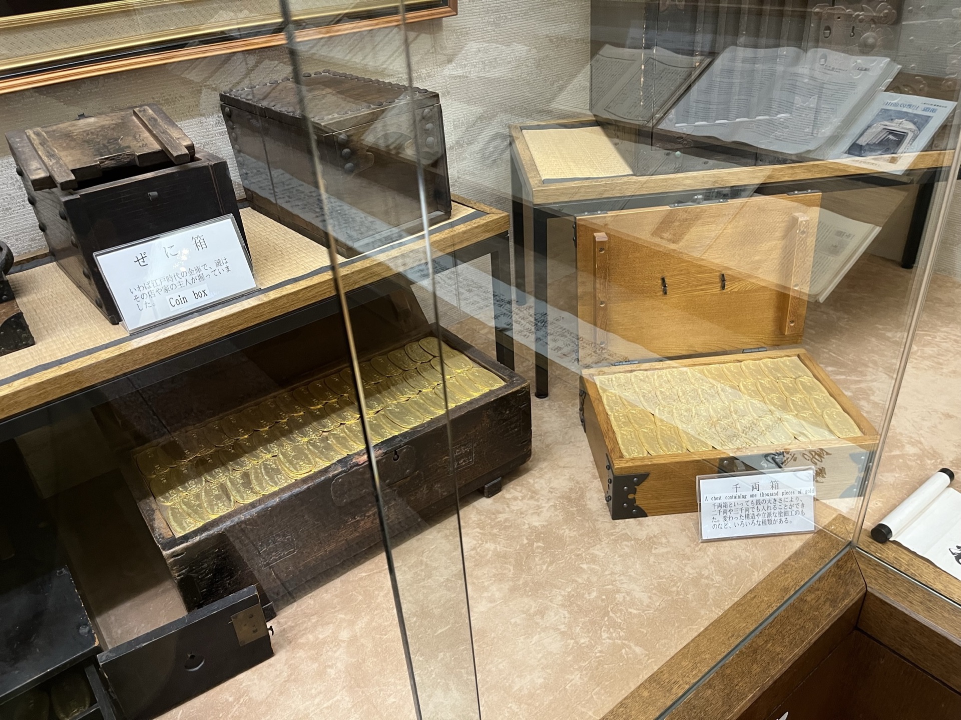 土肥金山入口木製招牌，白色布幔上寫「土肥金山」三字，背景為晴天
